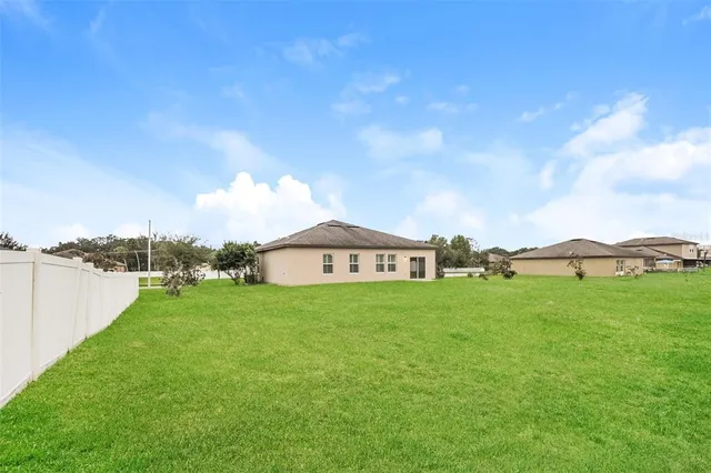 a view of a big yard next to a lake