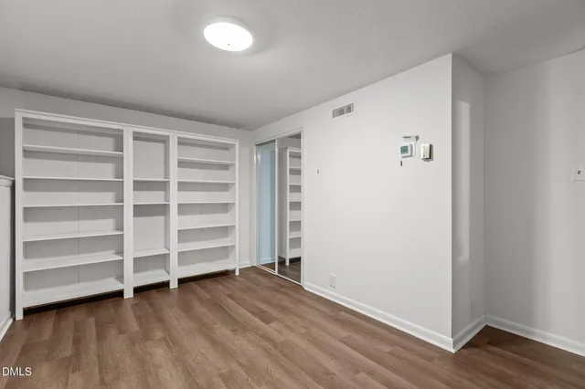 a view of walk in closet with empty racks