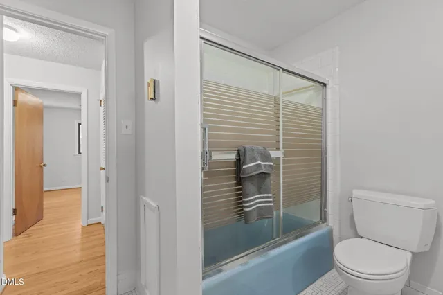 a bathroom with a toilet and a shower