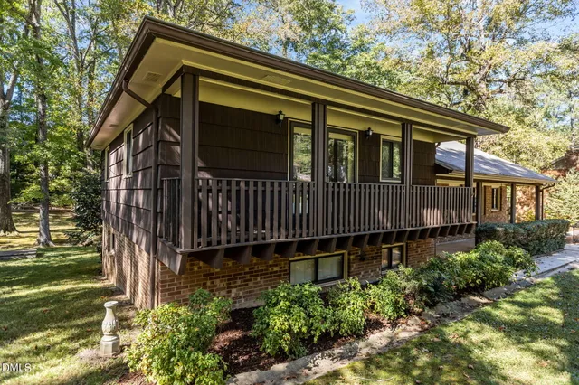 a backyard of a house with lots of green space and plants