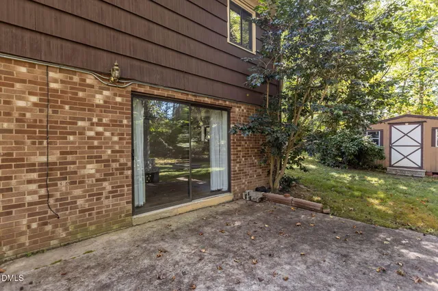 a view of backyard with large trees and plants