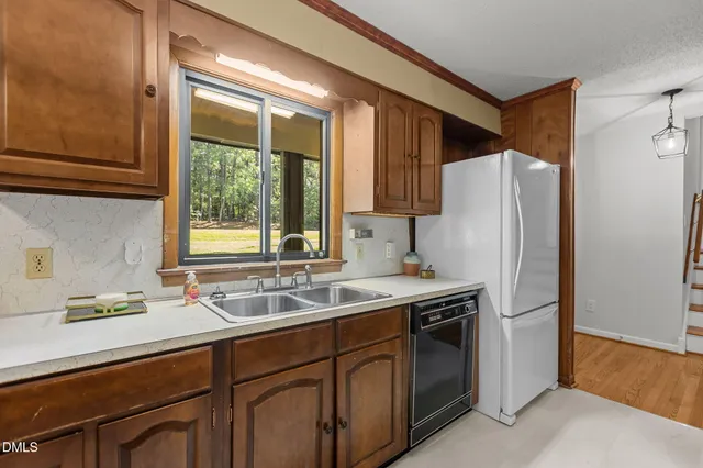 a kitchen with a sink a refrigerator and a sink
