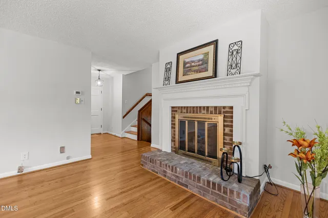 a view of a livingroom with wooden floor and a ceiling fan