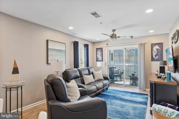 a living room with furniture and a floor to ceiling window