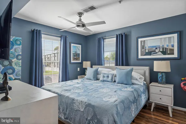 a bedroom with a large bed and a large window