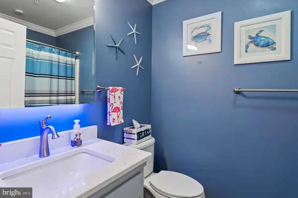a bathroom with a sink mirror vanity and toilet