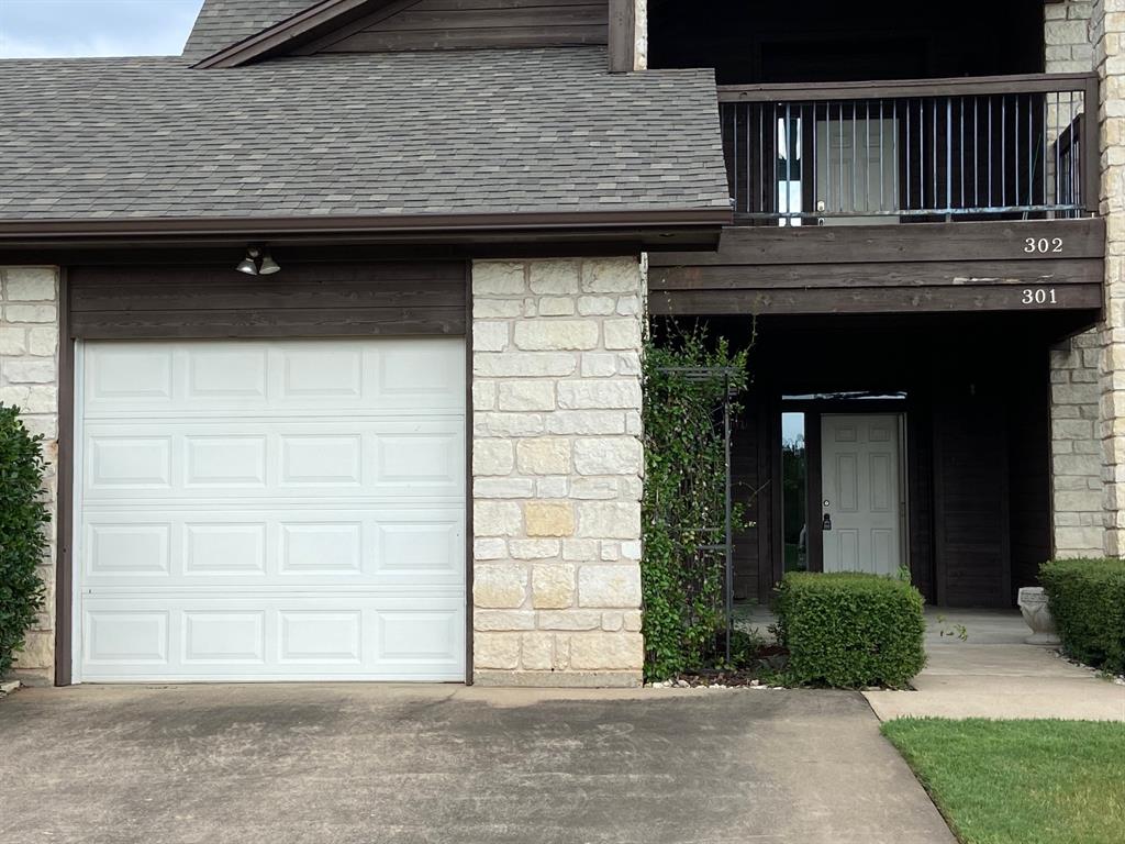 27101 Meadowmore Court Whitney, TX 76692 - Photo 3 of 32 Downstairs condo with attached 1-car garage.