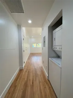 a view of hallway with wooden floor