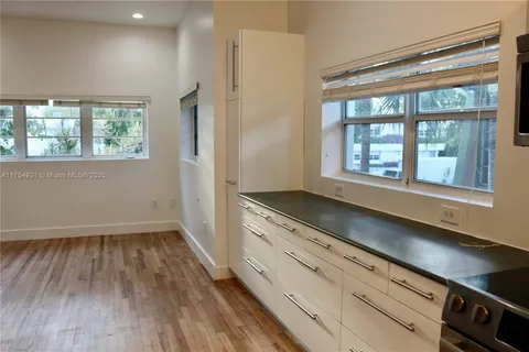 a kitchen with a sink and refrigerator