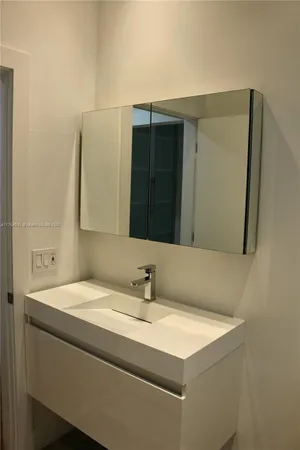 a bathroom with a shower and a sink
