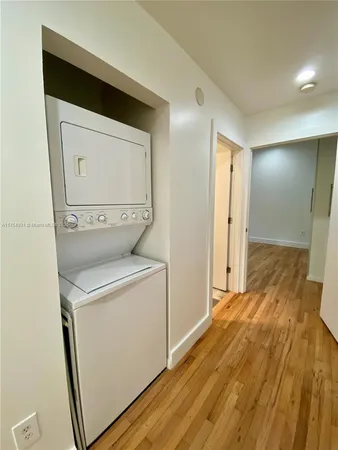 a view of storage and utility room with wooden floor