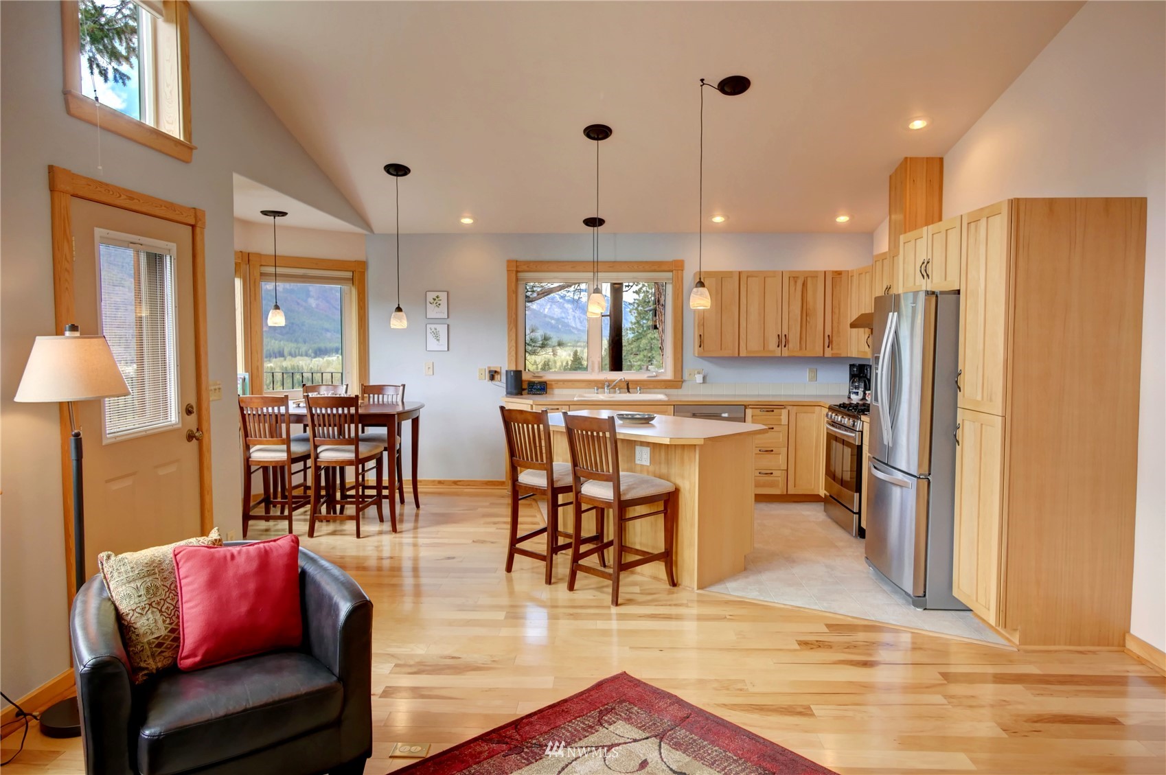 21 Bitterbrush Road Winthrop, WA 98862 - Photo 21 of 40 a kitchen with stainless steel appliances kitchen island granite countertop a dining table chairs and a refrigerator