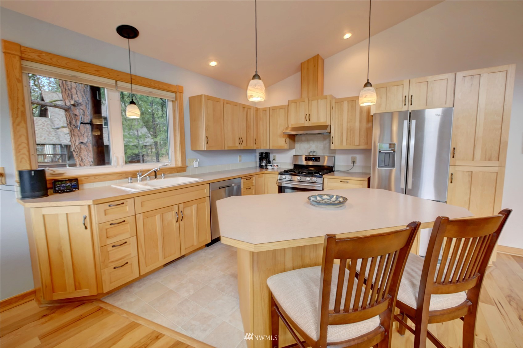 21 Bitterbrush Road Winthrop, WA 98862 - Photo 28 of 40 a kitchen with stainless steel appliances kitchen island granite countertop a sink a stove a refrigerator and island with wooden floor