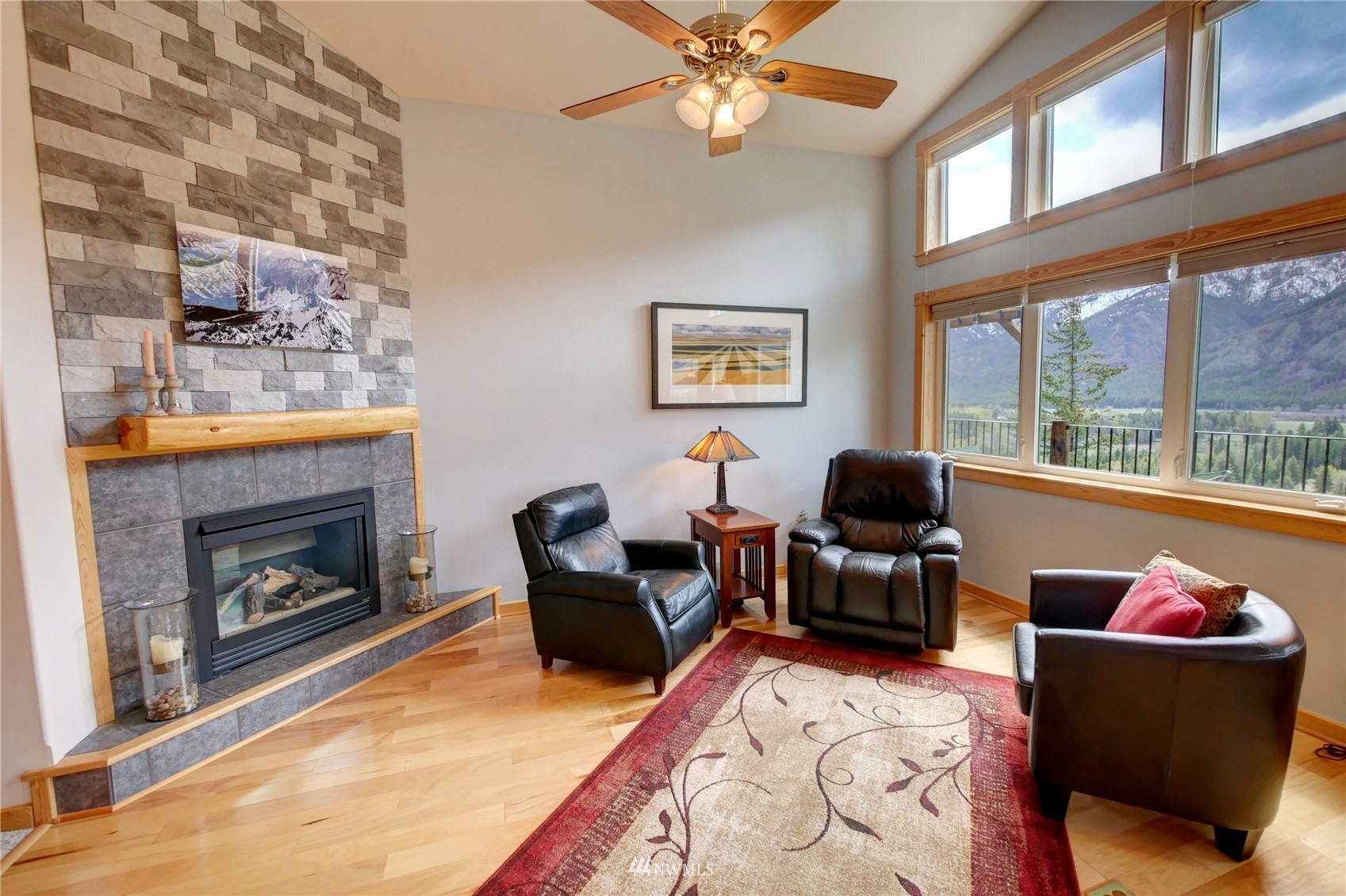 21 Bitterbrush Road Winthrop, WA 98862 - Photo 6 of 40 a living room with furniture a chandelier and a fireplace