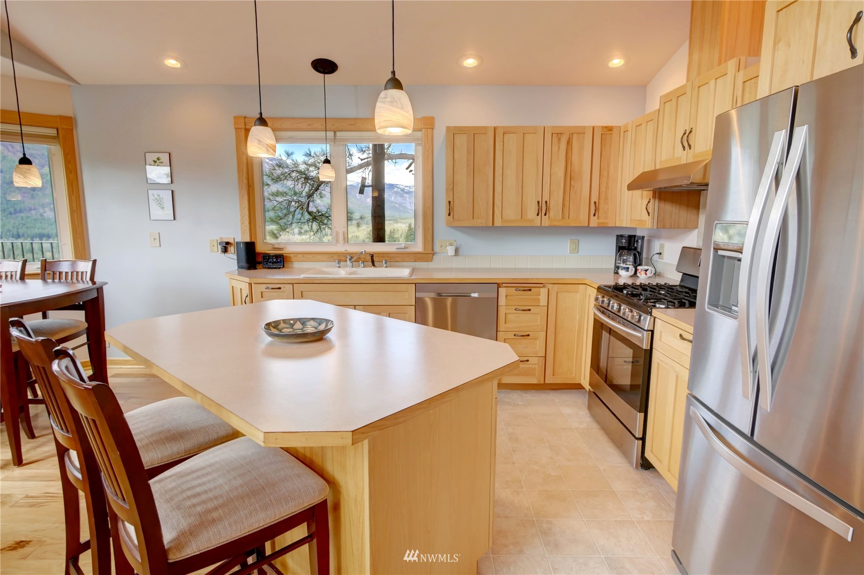 21 Bitterbrush Road Winthrop, WA 98862 - Photo 7 of 40 a kitchen with stainless steel appliances granite countertop a sink a stove a refrigerator and island