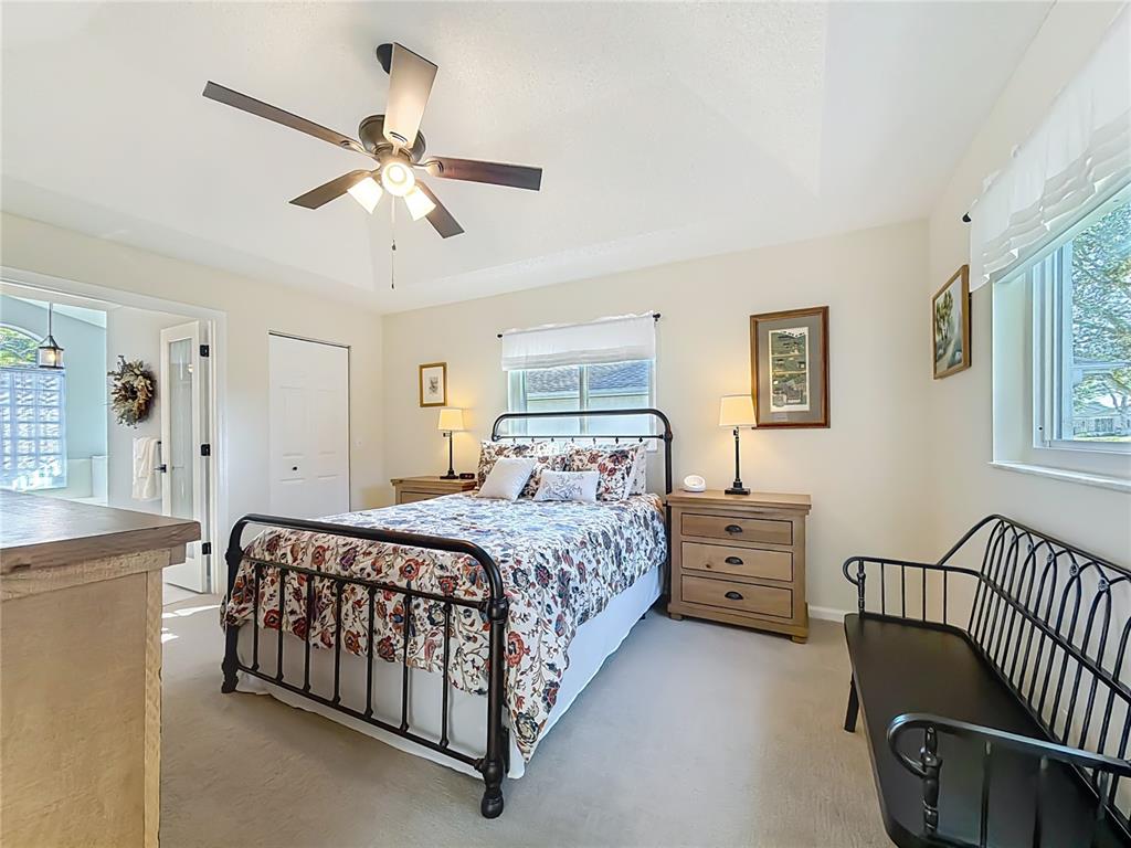 5226 Northwest 21st Loop Ocala, FL 34482 - Photo 17 of 57 a bedroom with a bed and a chandelier