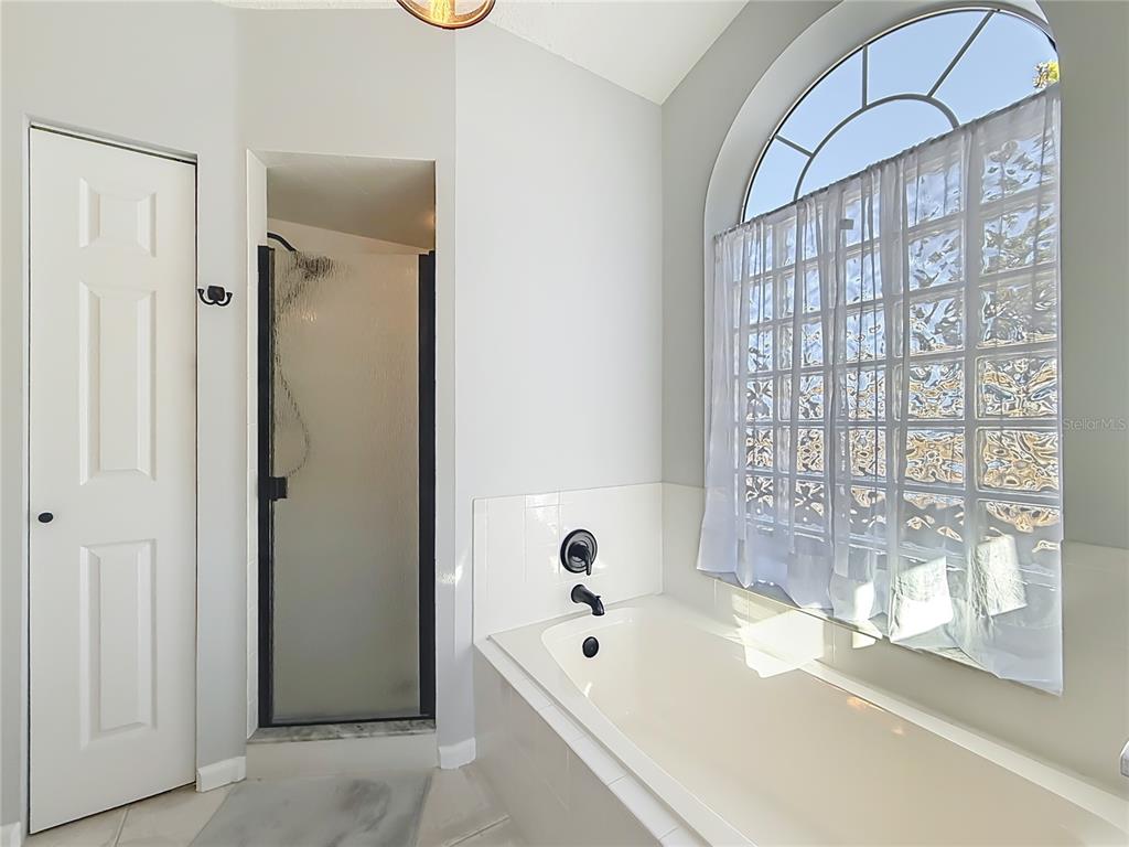 5226 Northwest 21st Loop Ocala, FL 34482 - Photo 21 of 57 a bathroom with a bathtub and a shower