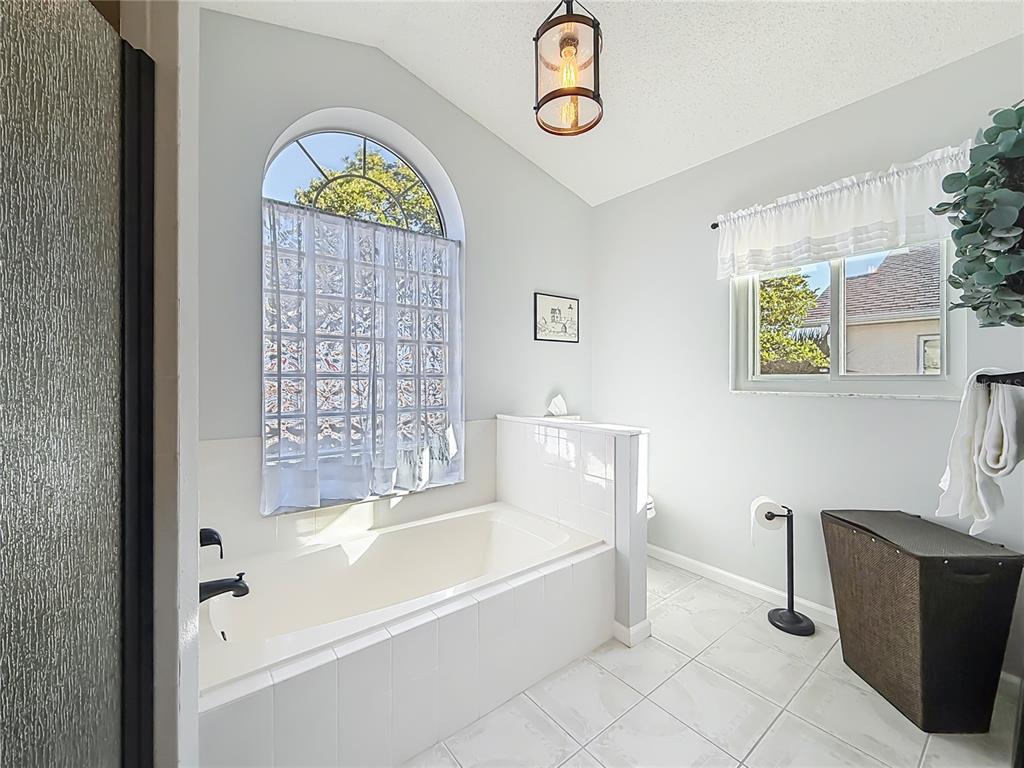 5226 Northwest 21st Loop Ocala, FL 34482 - Photo 22 of 57 a bathroom with a bathtub and a shower