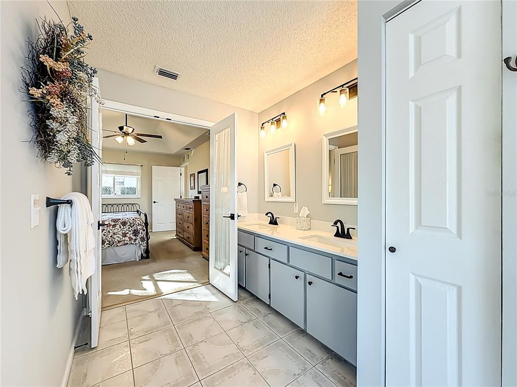 5226 Northwest 21st Loop Ocala, FL 34482 - Photo 23 of 57 a spacious bathroom with a double vanity sink and a mirror