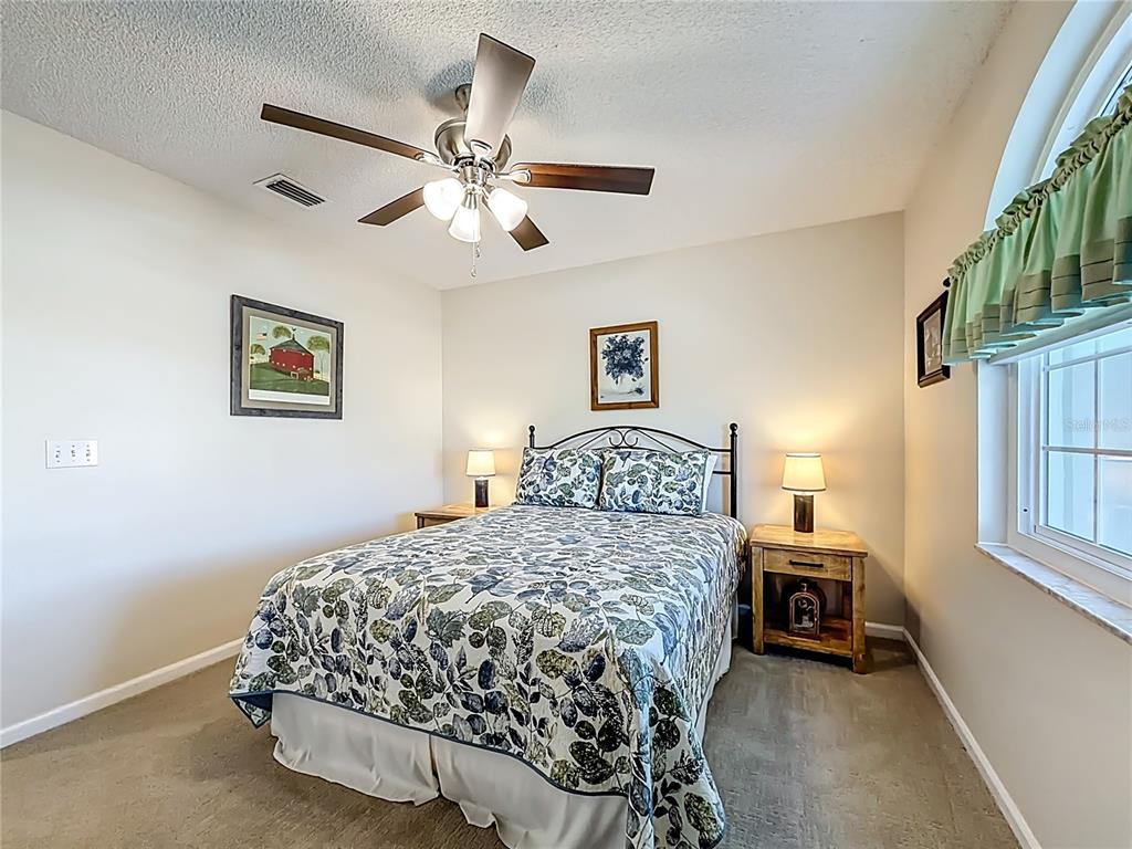 5226 Northwest 21st Loop Ocala, FL 34482 - Photo 25 of 57 a bedroom with a bed and a chandelier