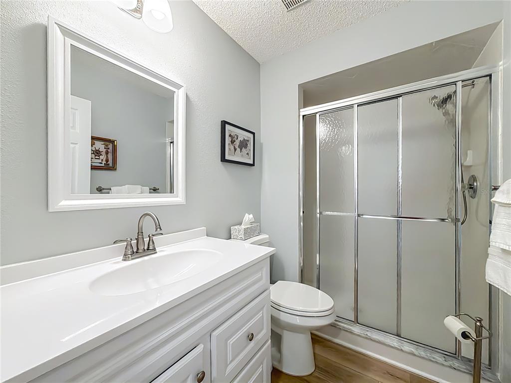 5226 Northwest 21st Loop Ocala, FL 34482 - Photo 27 of 57 a bathroom with a sink a toilet and shower