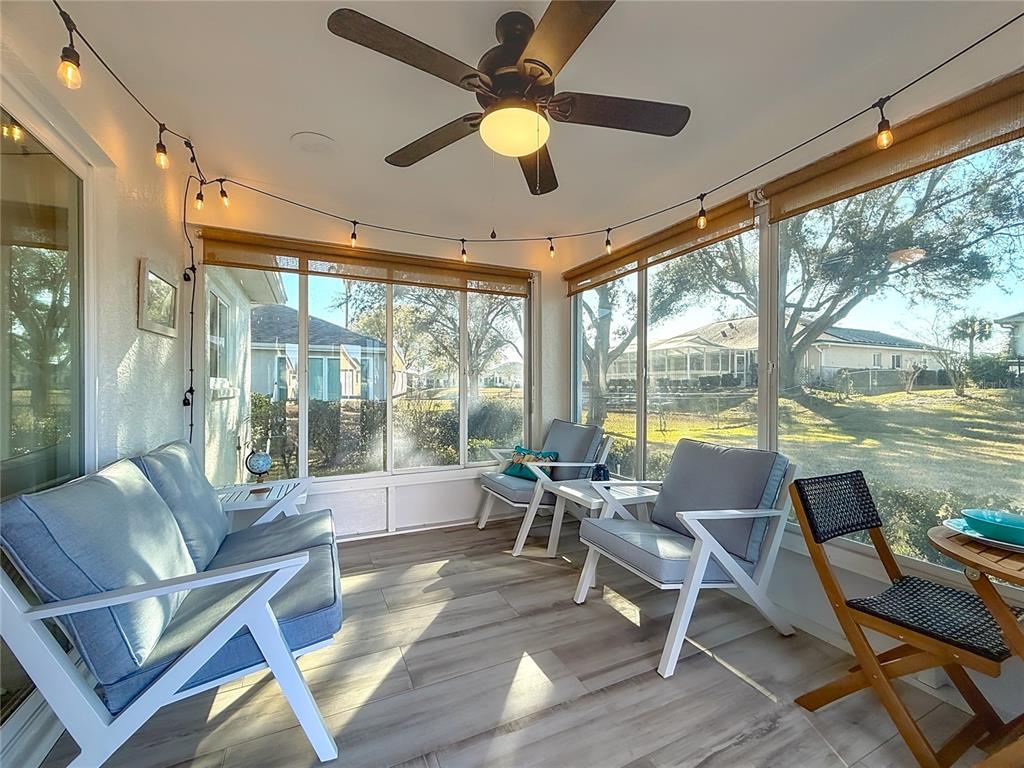 5226 Northwest 21st Loop Ocala, FL 34482 - Photo 31 of 57 a living room with a floor to ceiling window and wooden floor