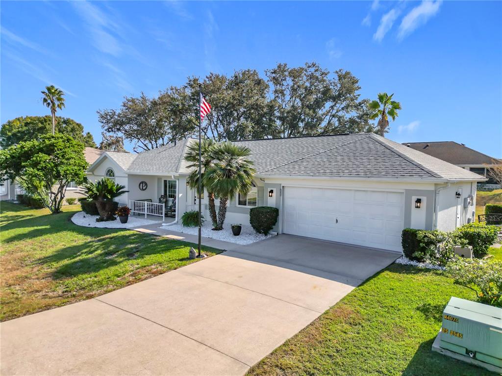 5226 Northwest 21st Loop Ocala, FL 34482 - Photo 44 of 57 a front view of a house with a yard and garage