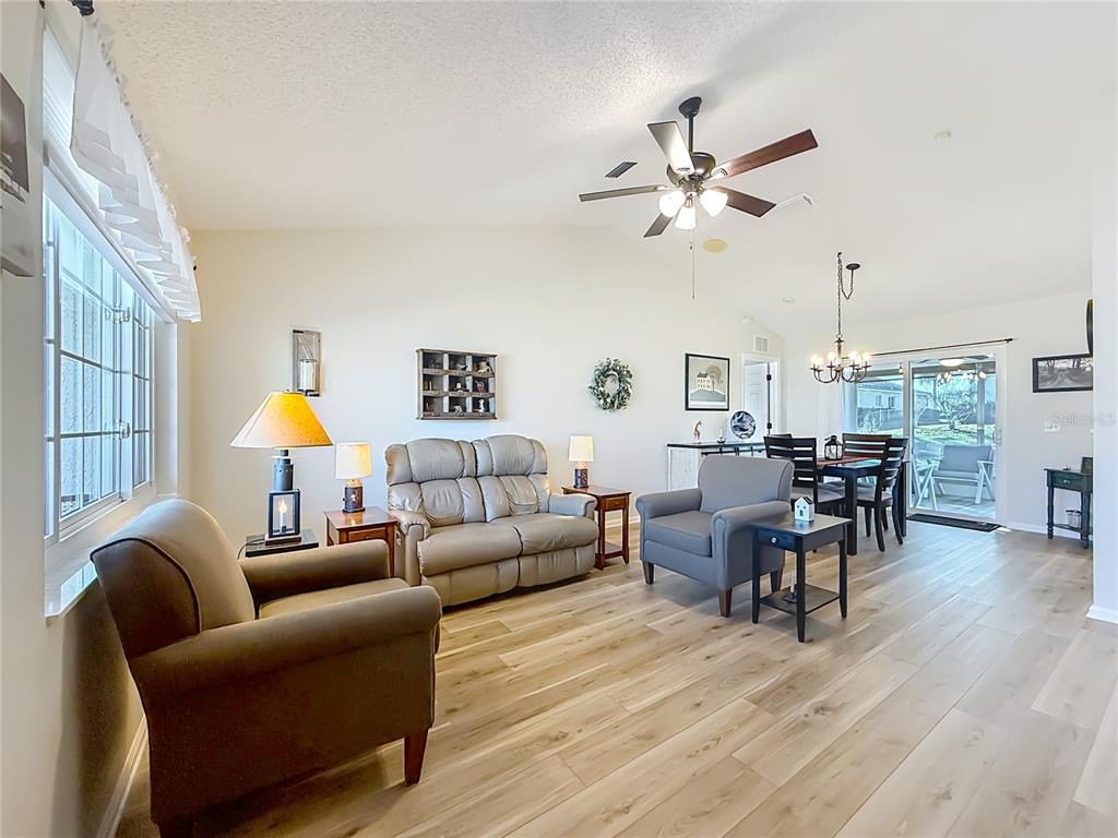 5226 Northwest 21st Loop Ocala, FL 34482 - Photo 5 of 57 a living room with furniture and a chandelier