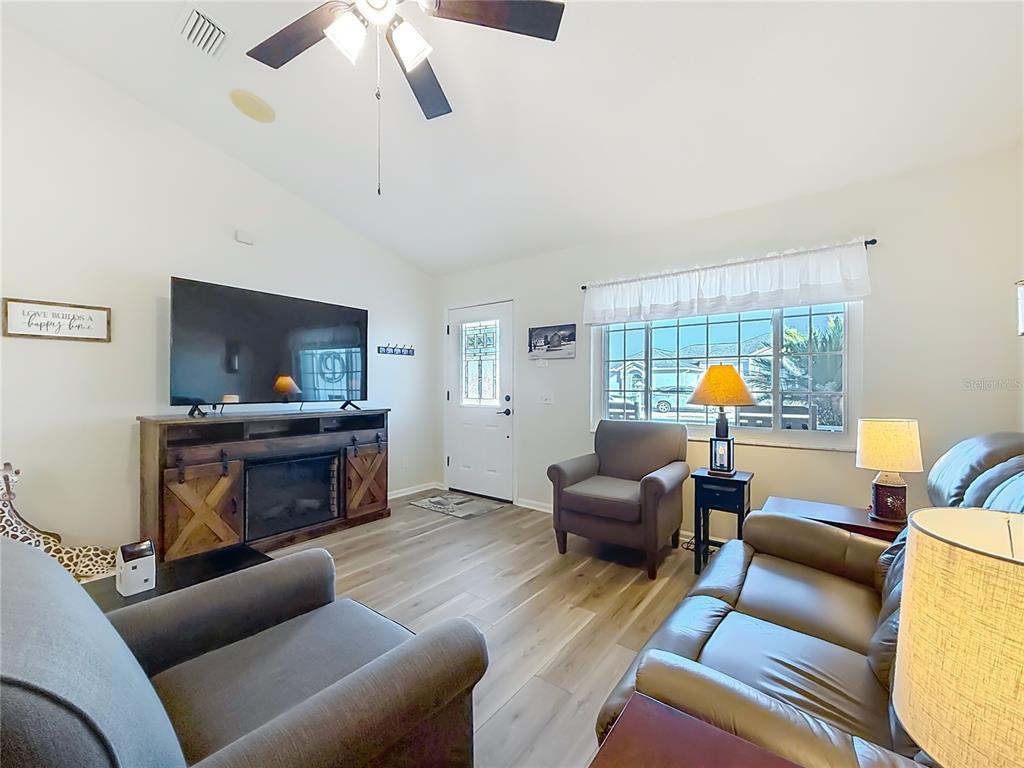 5226 Northwest 21st Loop Ocala, FL 34482 - Photo 6 of 57 a living room with furniture and a fireplace