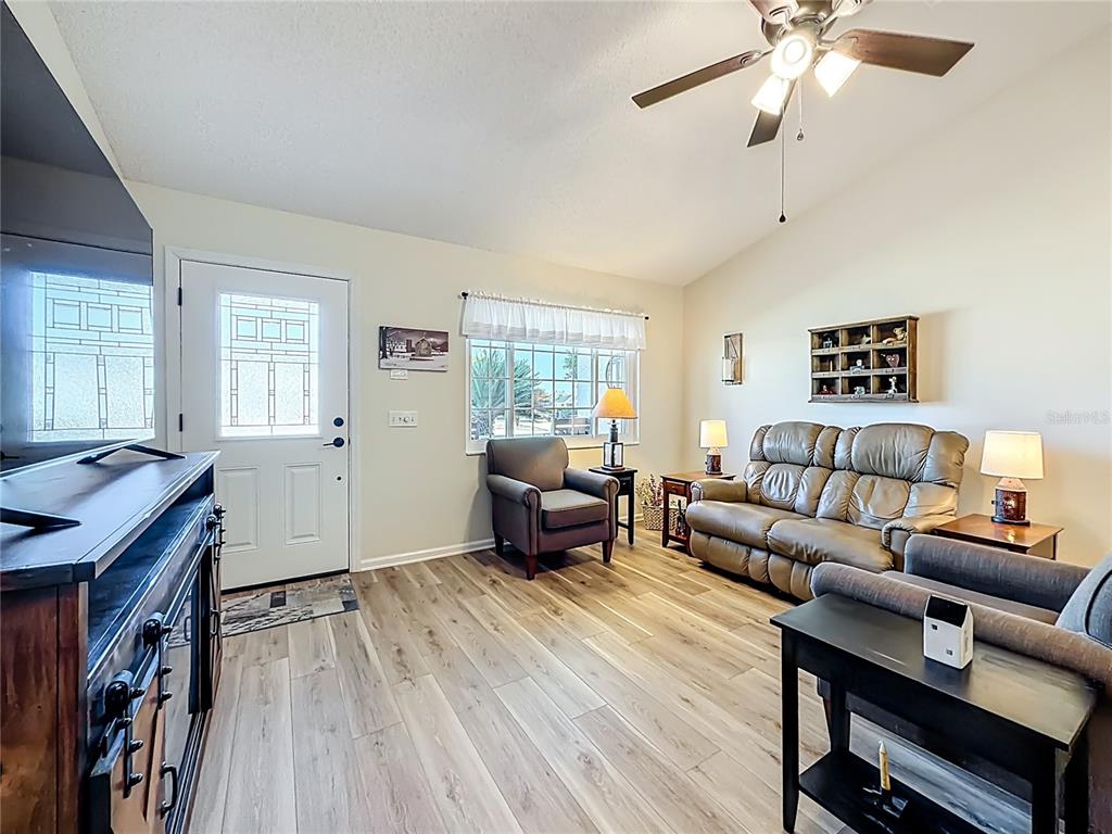 5226 Northwest 21st Loop Ocala, FL 34482 - Photo 7 of 57 a living room with furniture and a wooden floor