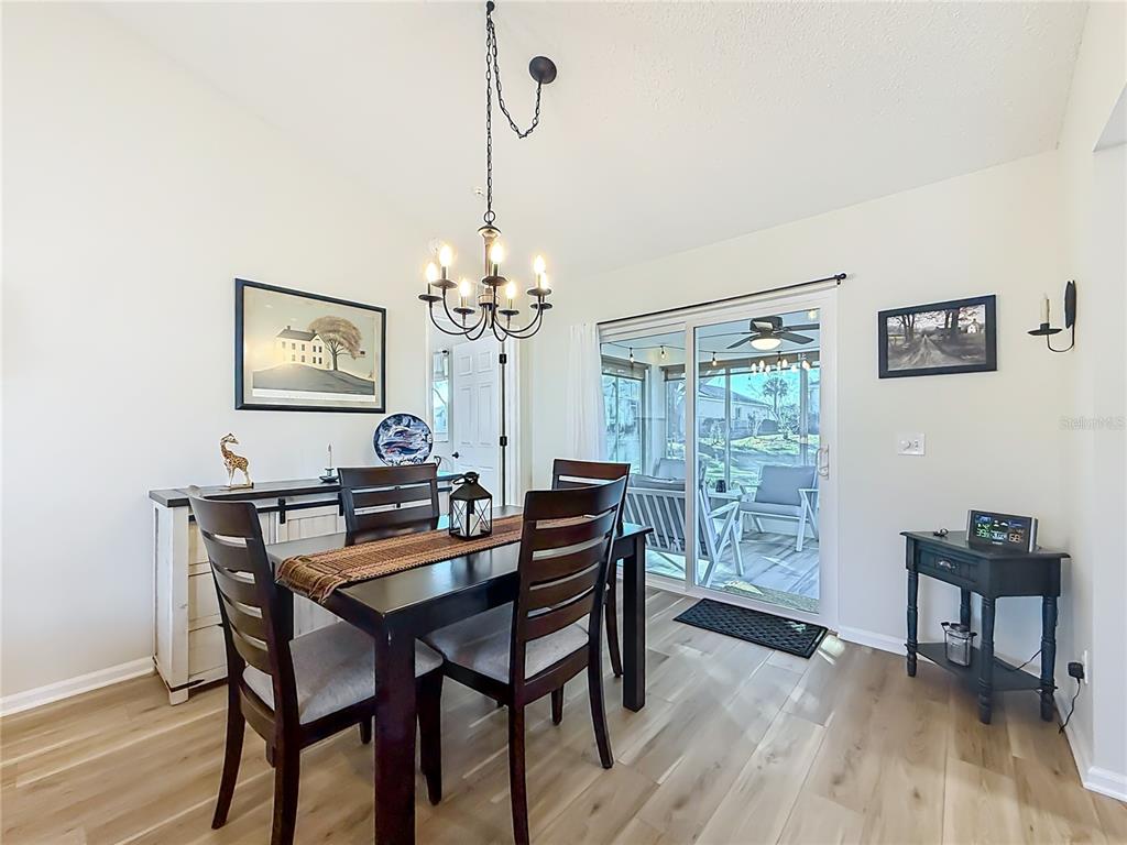 5226 Northwest 21st Loop Ocala, FL 34482 - Photo 8 of 57 a view of a dining room with furniture a rug and wooden floor