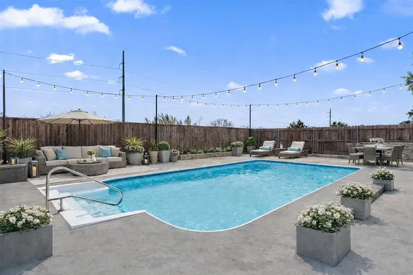a view of a swimming pool with a lounge chairs