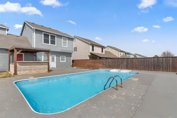 an aerial view of residential houses with yard