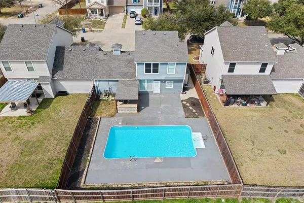 an aerial view of residential houses with outdoor space