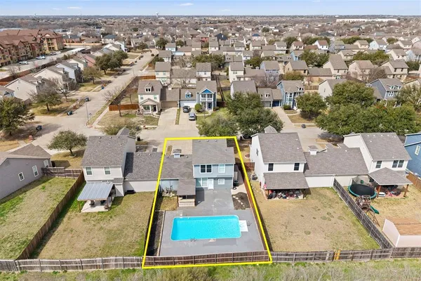 an aerial view of residential houses with outdoor space