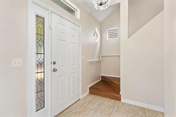 an empty room with ceiling fan and window