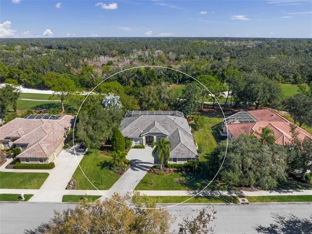 an aerial view of residential houses with outdoor space and lake view