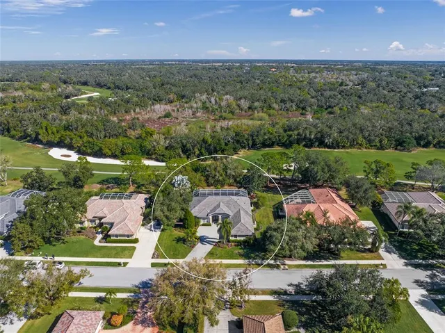 a view of a white house with a big yard and potted plants