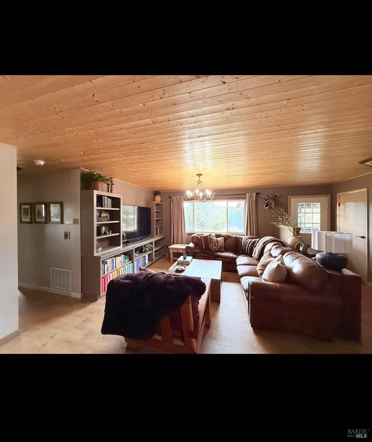 3004 Pencil Road Alturas, CA 96101 - Photo 13 of 40 a living room with furniture a large window and kitchen view