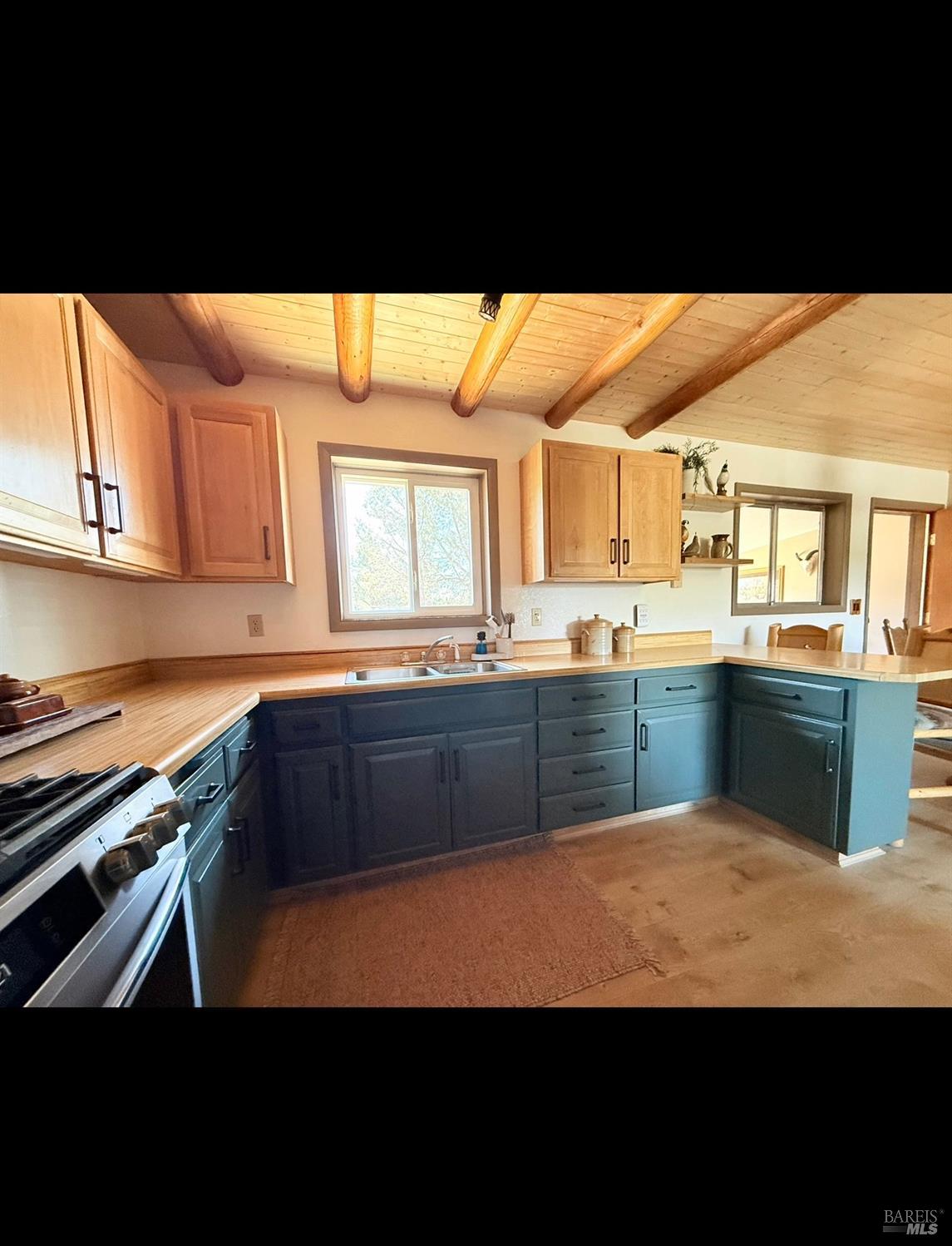 3004 Pencil Road Alturas, CA 96101 - Photo 19 of 40 a kitchen with stainless steel appliances a sink dishwasher and white cabinets with wooden floor