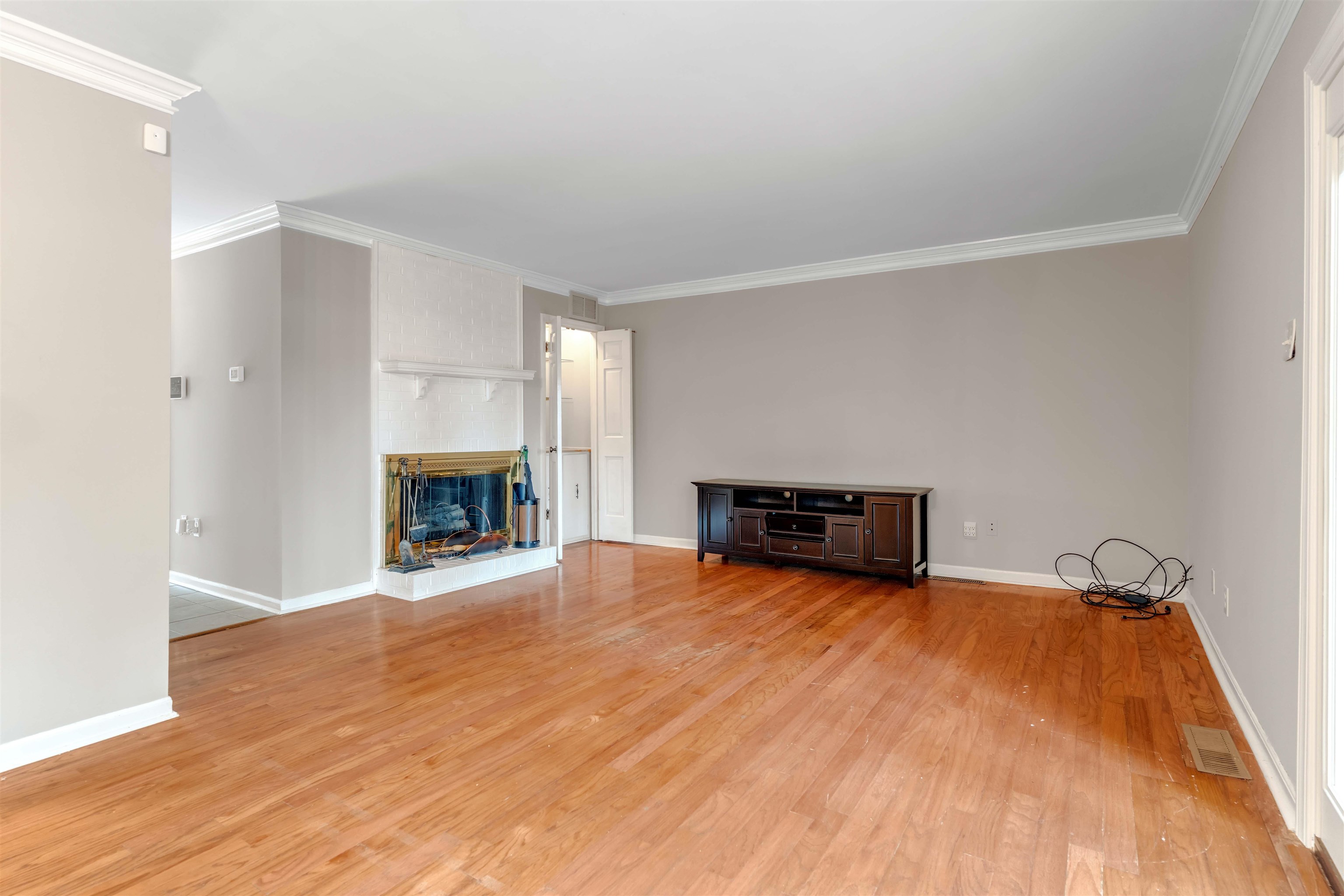 6942 Amberly Road, Unit 6942 Memphis, TN 38119 - Photo 13 of 32 a view of empty room with wooden floor and fireplace