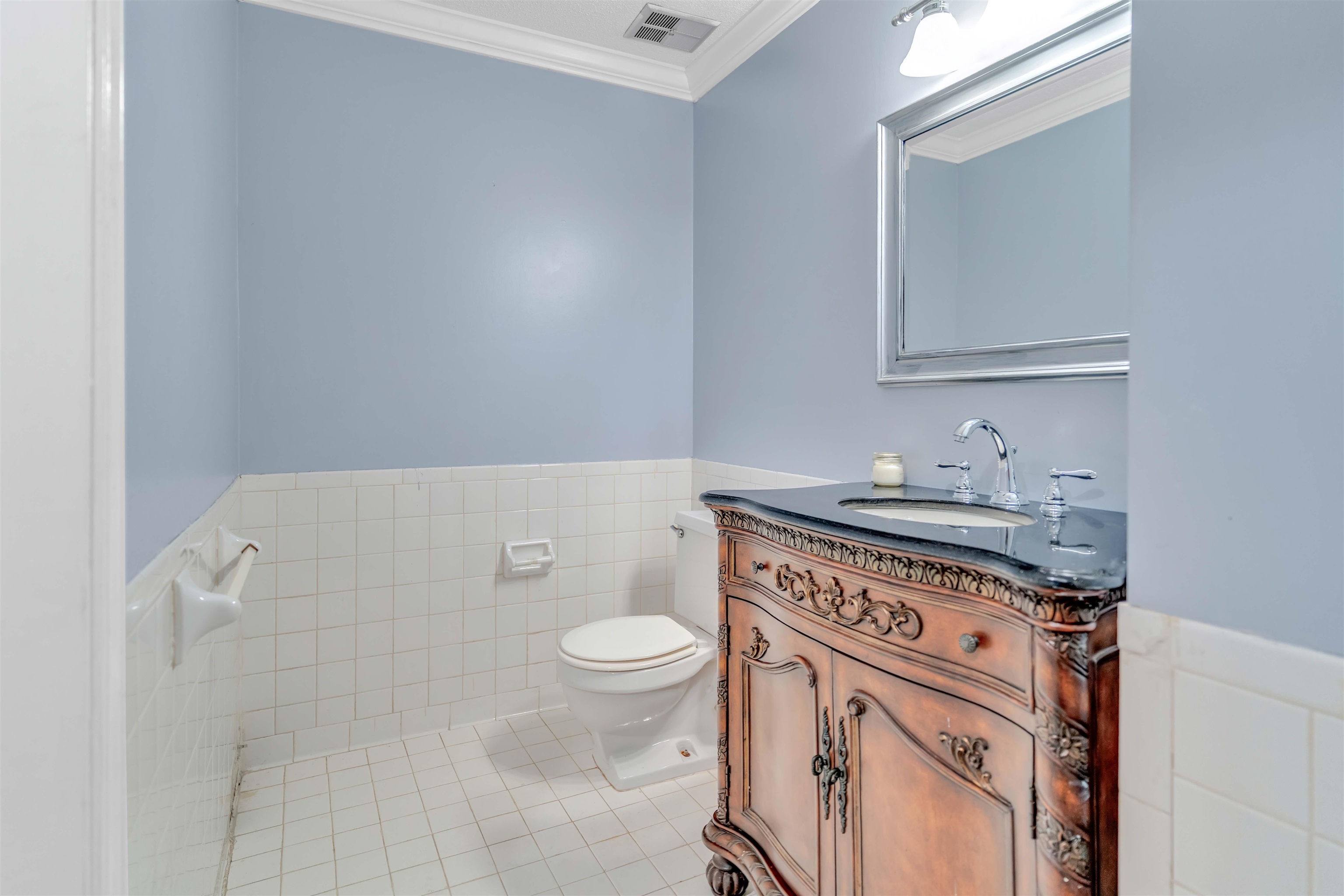 6942 Amberly Road, Unit 6942 Memphis, TN 38119 - Photo 16 of 32 a bathroom with a granite countertop toilet sink and mirror