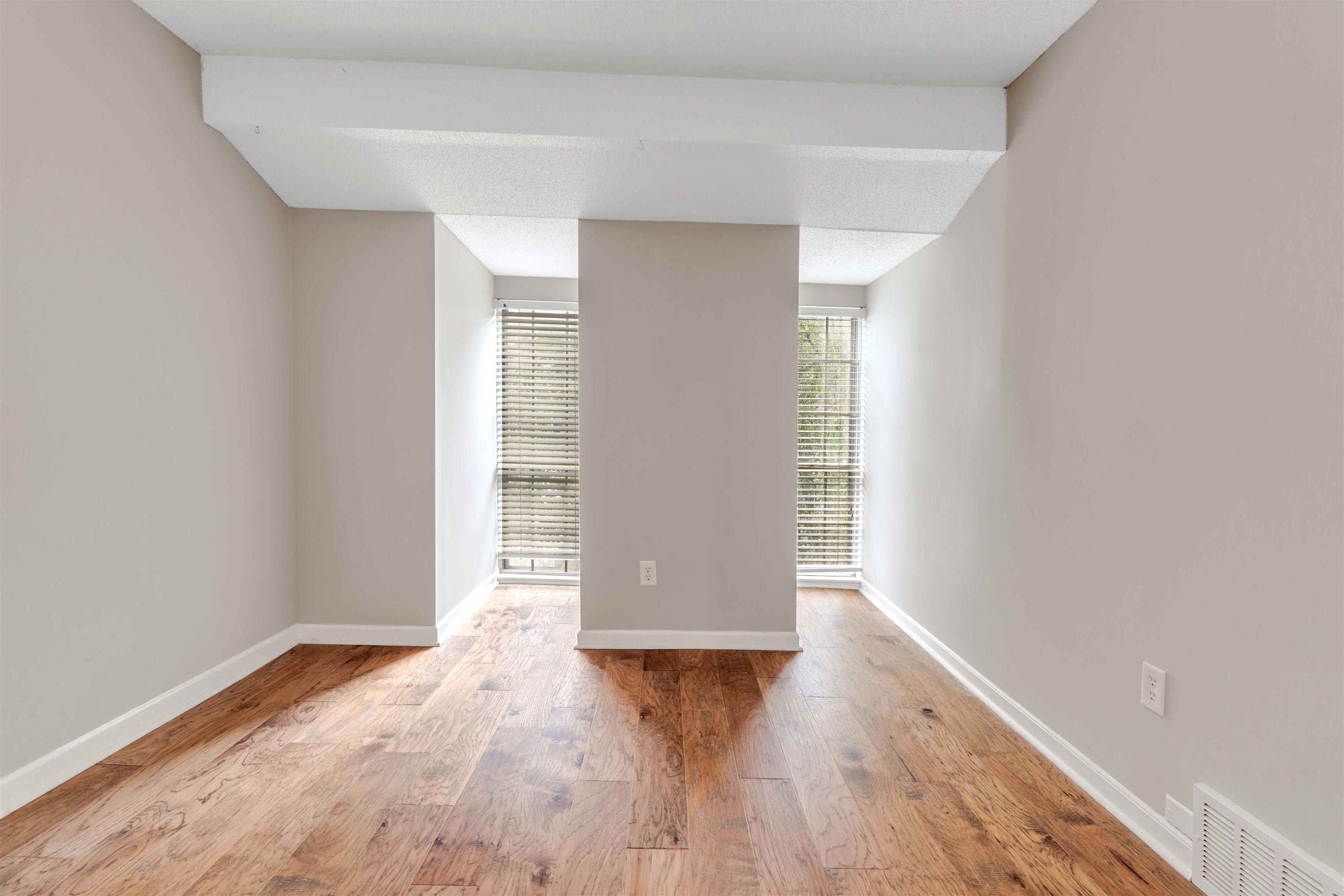 6942 Amberly Road, Unit 6942 Memphis, TN 38119 - Photo 20 of 32 a view of an empty room with wooden floor and a window