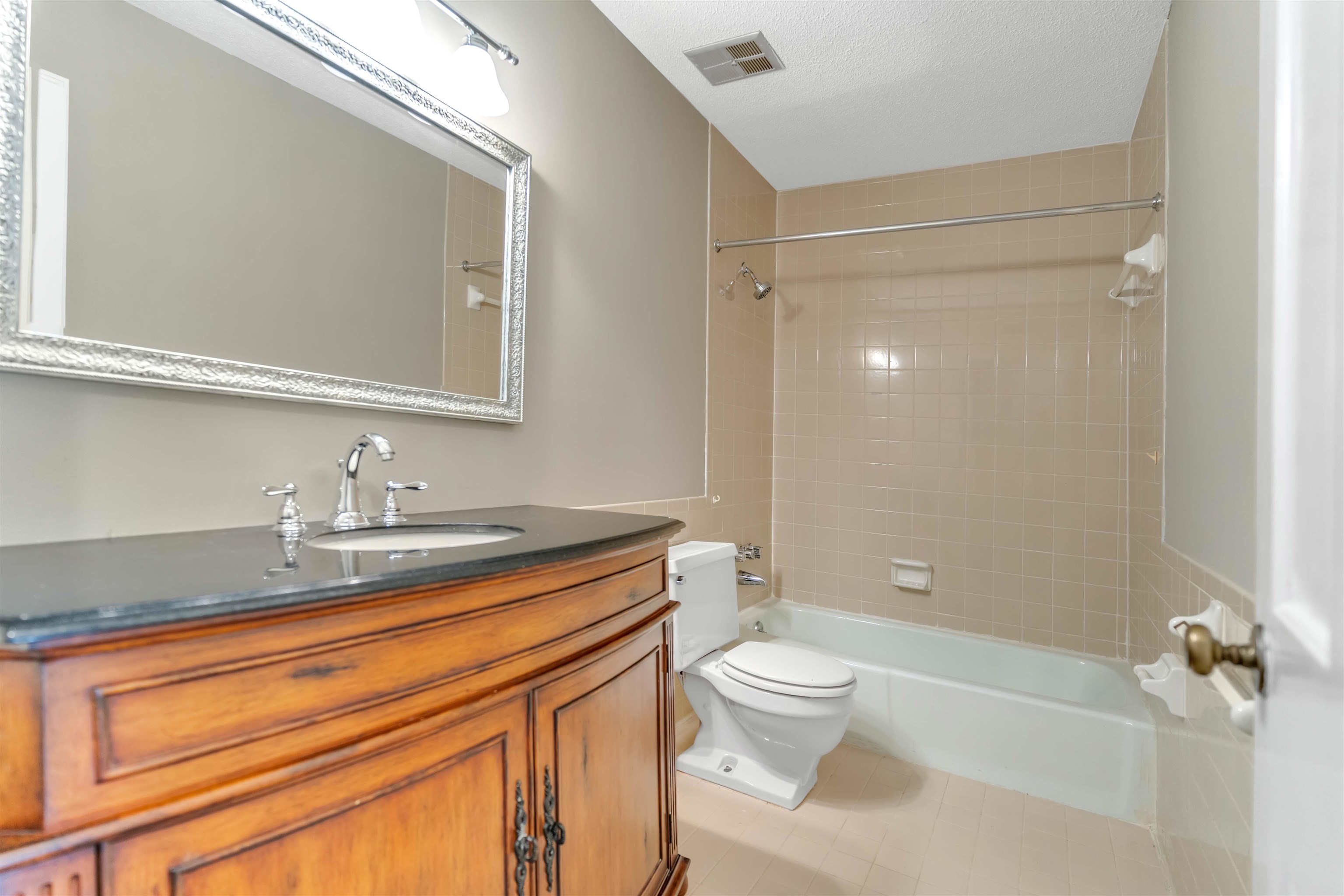 6942 Amberly Road, Unit 6942 Memphis, TN 38119 - Photo 21 of 32 a bathroom with a granite countertop sink toilet and shower