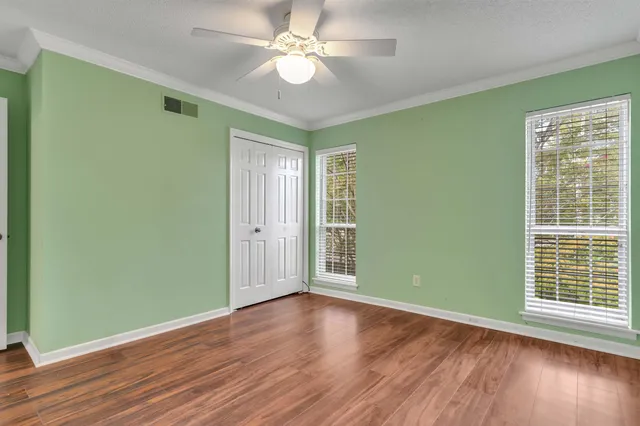 wooden floor in an empty room with a window