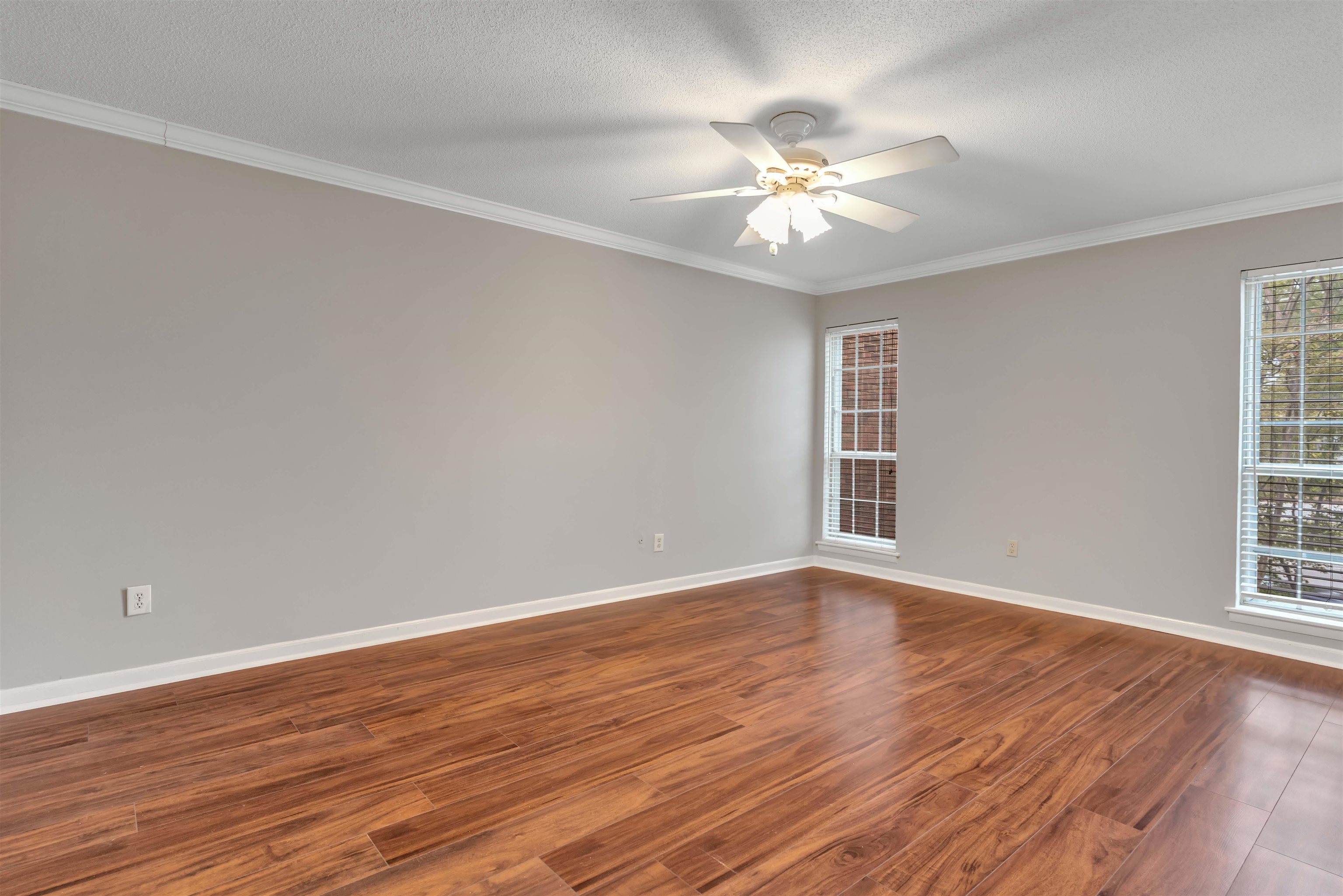 6942 Amberly Road, Unit 6942 Memphis, TN 38119 - Photo 24 of 32 a view of an empty room with wooden floor and a window