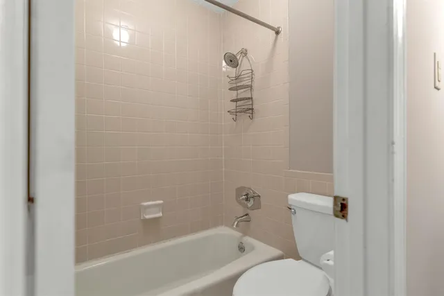 a bathroom with a toilet and a shower