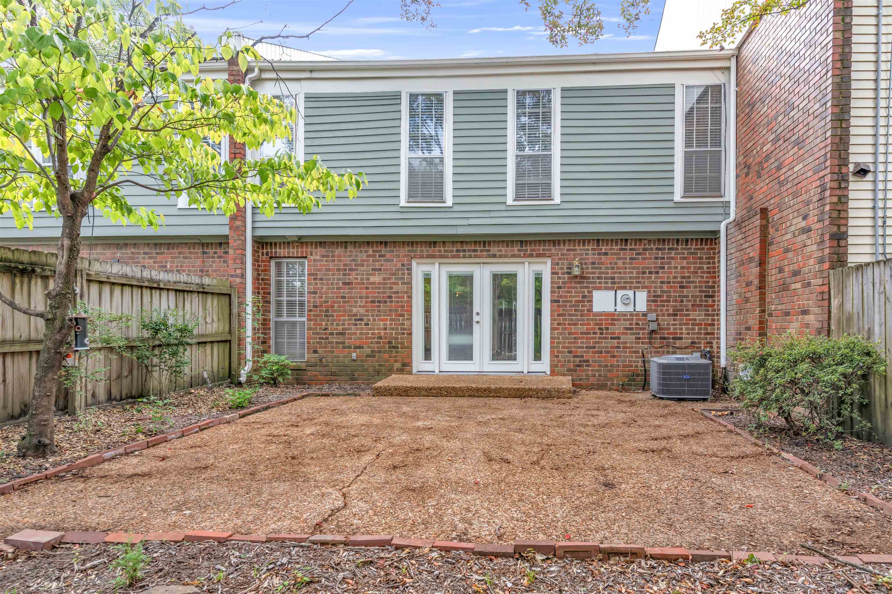 6942 Amberly Road, Unit 6942 Memphis, TN 38119 - Photo 28 of 32 a front view of a house with a yard and garage