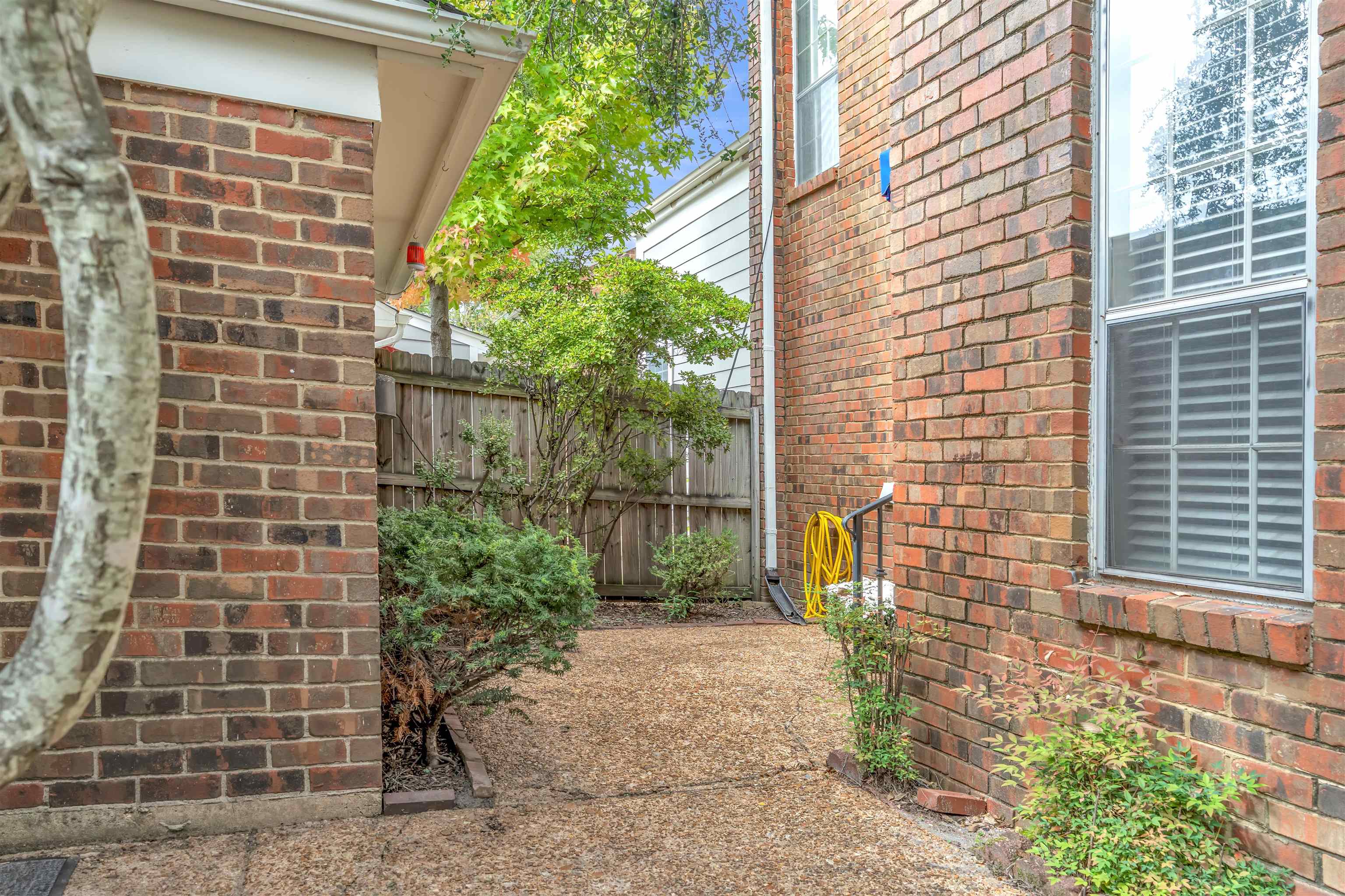 6942 Amberly Road, Unit 6942 Memphis, TN 38119 - Photo 3 of 32 a front view of a house with a garden