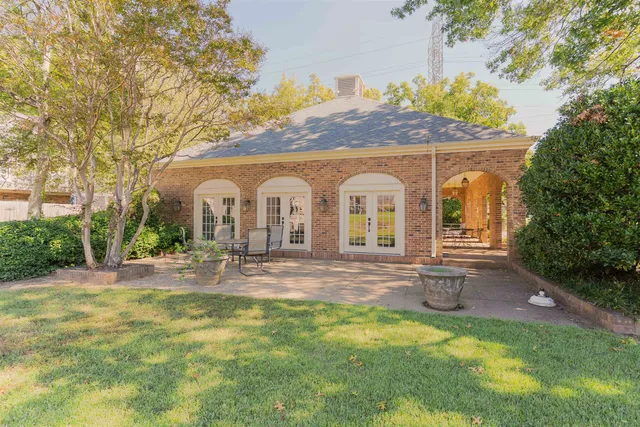 a view of house with backyard and garden
